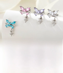 Macro detail of butterfly dangle earrings with titanium steel studs and zircon stars