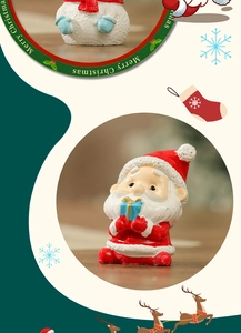 Macro detail of a resin Santa figurine holding a blue gift for Christmas decor