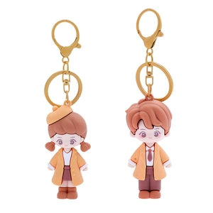 Cartoon couple PVC keychains in orange and yellow with golden metal lobster clasps
