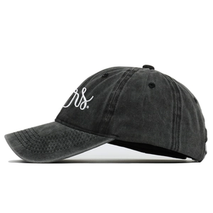 Detail of vintage washed cotton baseball cap featuring white 'rs.' cursive embroidery