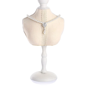 Close-up of white teardrop pearl necklace with sparkling rhinestone pendant on model
