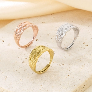 Detailed view of woven texture adjustable rings in gold silver and rose gold metal