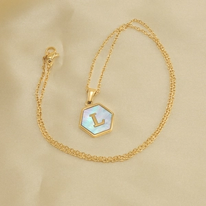 Golden hexagon necklace with iridescent mother of pearl and a 3D letter L pendant