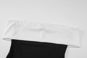 Detailed view of black and white contrast strapless top with folded neckline design