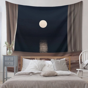 Detailed view of bohemian moonlit sea tapestry hung in a cozy minimalist bedroom setup