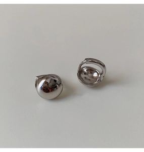 Close-up of highly polished silver sphere hoop earrings with a sleek metallic mirror finish