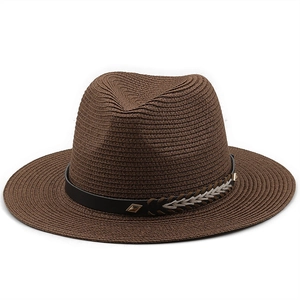 Detail of dark brown fedora straw hat showing woven texture and gold rivet band