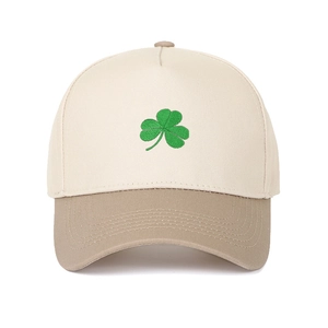 Detail of green shamrock embroidery on a cream and khaki five-panel trucker hat