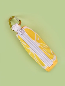 Close-up of yellow printed canvas pet waste bag dispenser with gold metal carabiner hook
