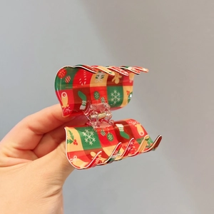 Christmas hair claw clip with festive red and green plaid patterns and snowflake elements
