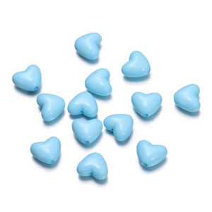 Detailed view of smooth light blue heart-shaped acrylic beads for DIY jewelry making