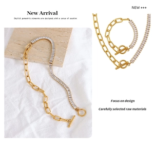 Macro detail of gold OT toggle necklace with chunky chain and rectangular zircon links