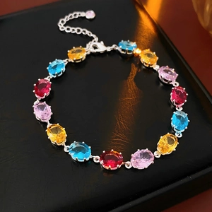 Macro shot of oval-cut multicolor zircon stones on a silver-tone adjustable bracelet