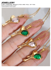 Detail of melting heart pendant necklaces with green and purple teardrop crystals