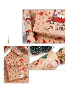 Detail of Christmas gift wrapping paper roll with festive Santa and reindeer patterns
