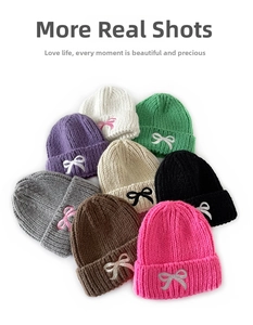 Flat lay of knit beanies in multiple candy colors with cute bow embroidery details