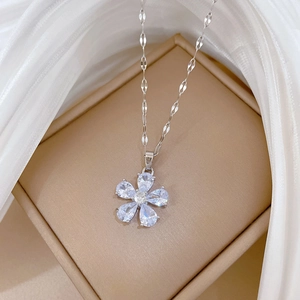 Macro detail of silver flower pendant with sparkling pear-cut cubic zirconia and flat link chain