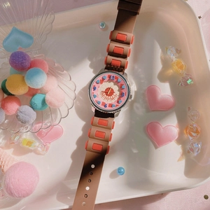 Detail shot of biscuit-themed girl's watch with pink dial and colorful silicone strap