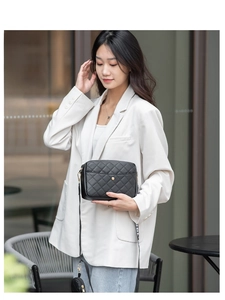 Close-up of quilted crossbody bag with stylish wide nylon strap and coin purse