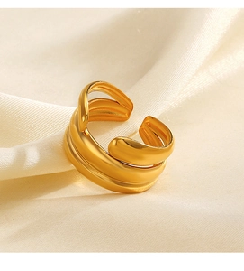 Macro shot of gold layered wrap open ring on soft silk background for women