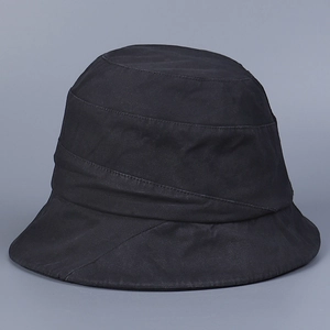 Close-up of black cotton bucket hat featuring diagonal pleated textures and stitched details