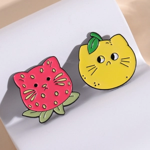 Cute enamel fruit pins set featuring strawberry and lemon cartoon cats in bright colors