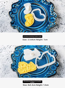 Detail of Christmas stocking and house shaped cookie cutters on a vintage blue plate