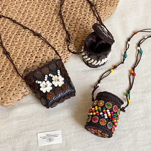Detailed close-up of handmade bohemian coconut shell woven bag with colorful wood beads
