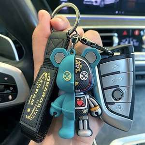Detailed close-up of blue robotic bear keychain with mechanical gears and woven wrist strap