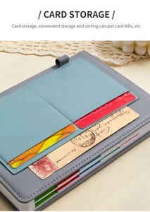 Detail of light blue faux leather card storage slots inside an undated daily planner