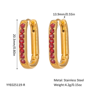 Detail of gold U-shaped earrings with red gemstones and dimension measurements
