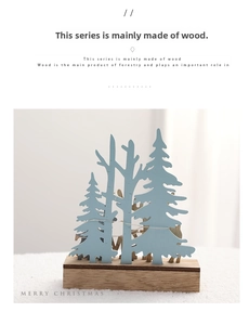 Detail of multi-layered wooden Christmas reindeer ornament with blue tree and LED fairy lights