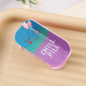 Detail of glitter PVC pill-shaped hair claw with Chill Pill text and cute smiley face