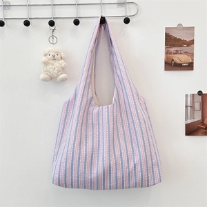 Detail of pink and blue seersucker striped canvas tote bag with textured fabric detail