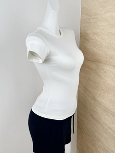 Side view of white slim-fit ribbed cotton T-shirt on a mannequin showing the fabric texture