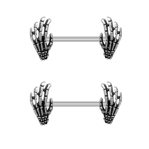 Detailed macro view of two skeleton hand nipple rings in vintage silver finish