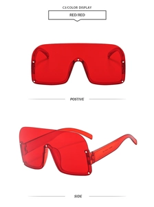 Detail view of stylish bright red semi-rimless wraparound sunglasses with clear frames