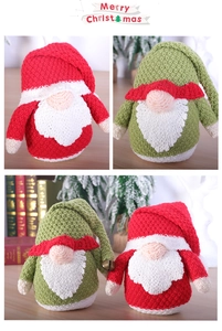 Close-up of knitted red and green Christmas gnomes with bell details and wool textures