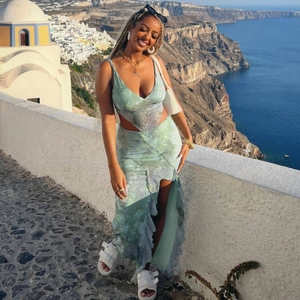 Green floral two-piece set featuring halter crop top and slit irregular skirt with sea view