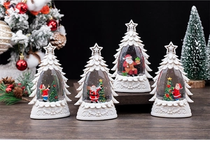 Detailed set of four white tree-shaped Christmas crystal balls with snowy festive scenes