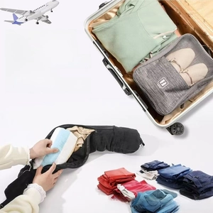 Détail du kit de voyage montrant un sac en filet gris et une housse d'oreiller noire