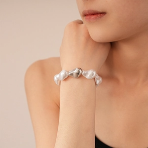 Gros plan d'un bracelet en perles baroques avec perle irrégulière en métal argenté