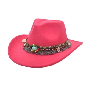 Detail of rose pink western cowboy hat featuring colorful ethnic beads and tassels