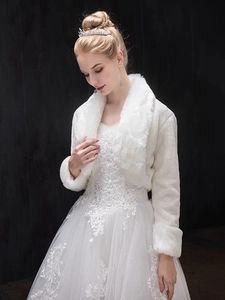 Close-up of elegant white faux fur bridal shawl with plush collar for wedding gowns