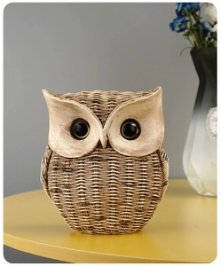 Detailed view of resin owl statue with realistic woven texture on a yellow round table