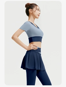 Detailed side view of high-stretch yoga set with contrast panels and pleated skirt detail