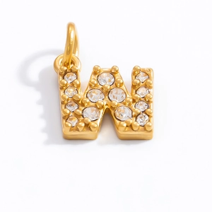 Close-up of golden letter W pendant with sparkling white rhinestones and a polished finish