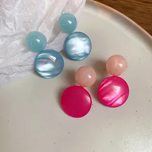 Minimalist round resin earrings with iridescent pearl texture in blue and pink hues