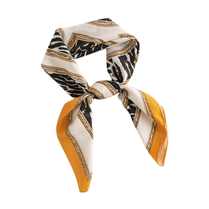 Elegant leopard print silk scarf with golden chains and yellow borders in a tied knot
