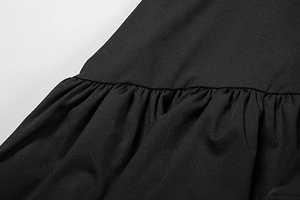 Detailed macro view of the ruffled black fabric and gathered seam of the summer dress